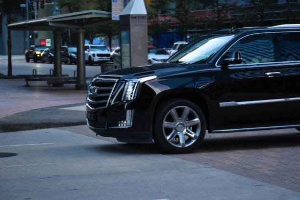 Black Cadillac Escalade luxury SUV on the road