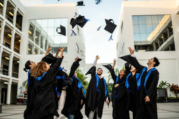 Graduates celebrating in caps and gowns